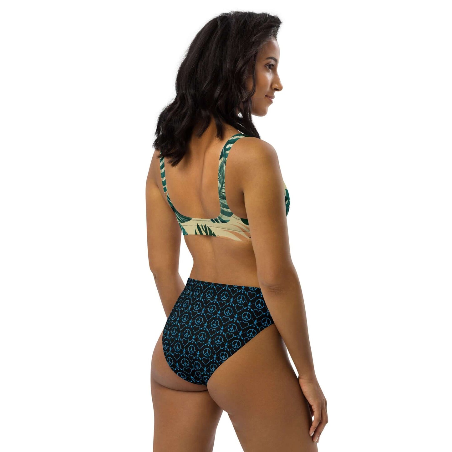 Model showcasing high-waisted Recycled Peace Love Paddleboard bikini, featuring vibrant patterns and a comfortable fit.
