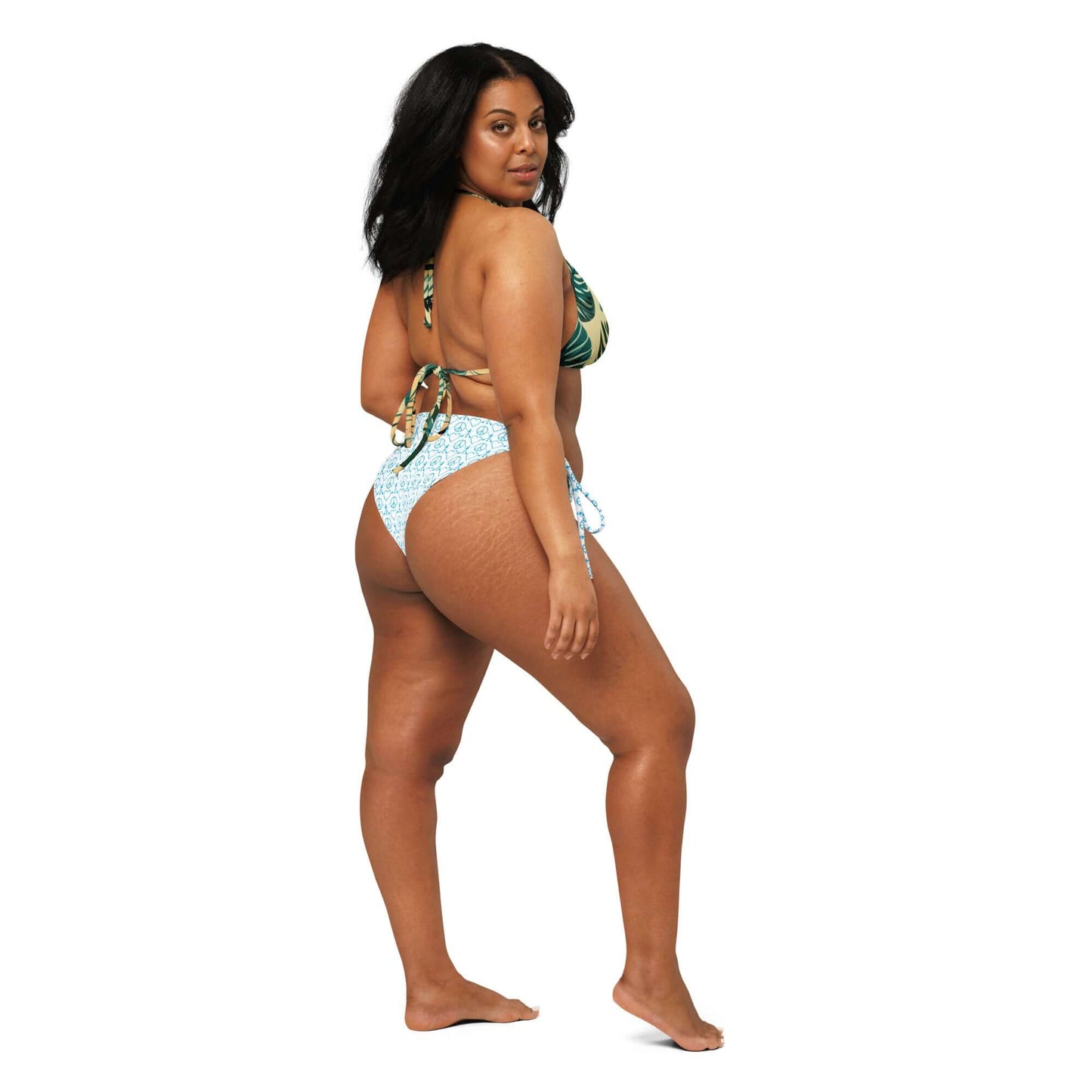 Woman showing off a Recycled Peace Love Paddleboard string bikini in vibrant colors, perfect for summer swims.