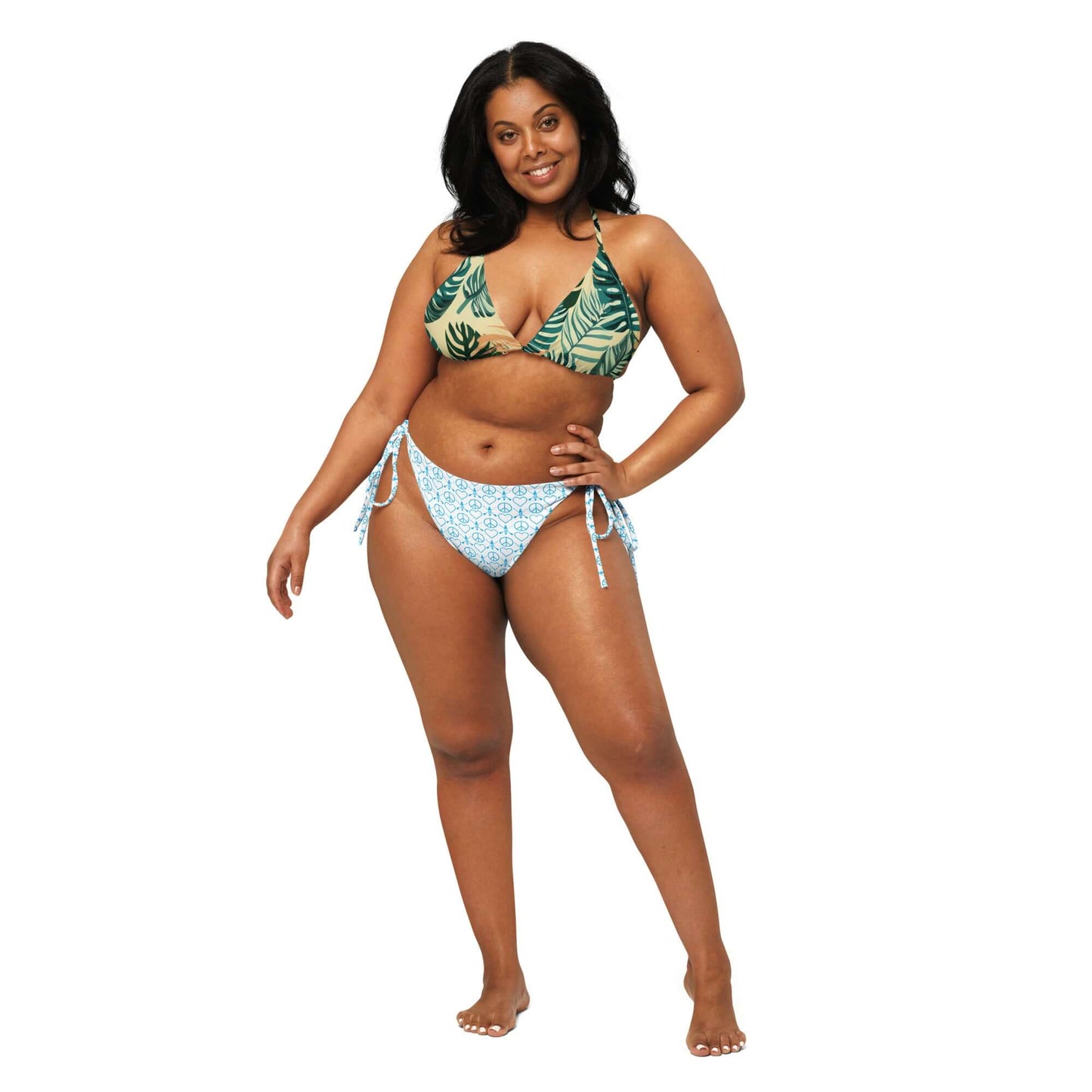 Recycled Peace Love Paddleboard string bikini in tropical print, model showcasing a stylish and comfortable beach look.