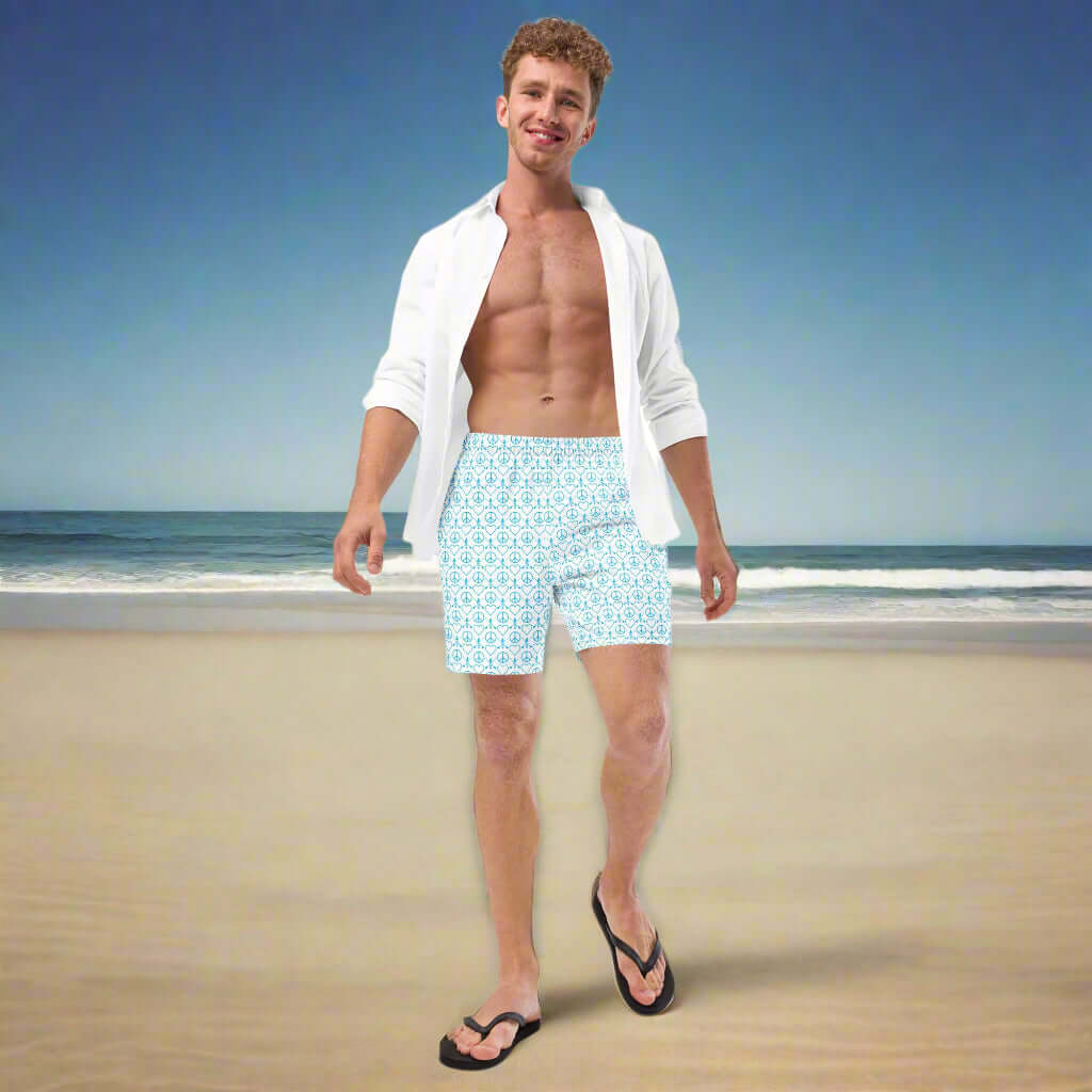 Man wearing Recycled Peace Love Paddleboard Swim Trunks on a beach, exuding summer vibes.
