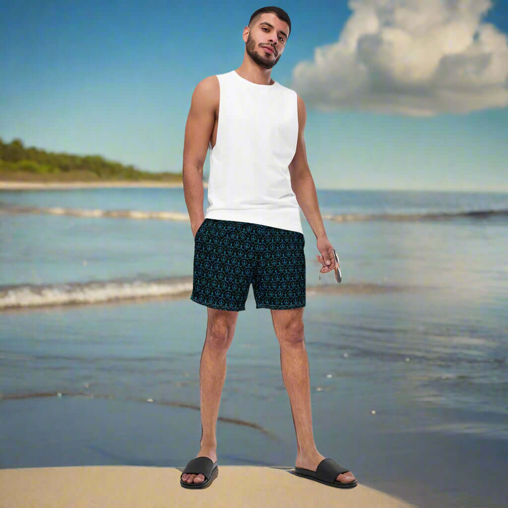 Man in recycled swim trunks on beach, showcasing summer style and comfort with quick-dry fabric.