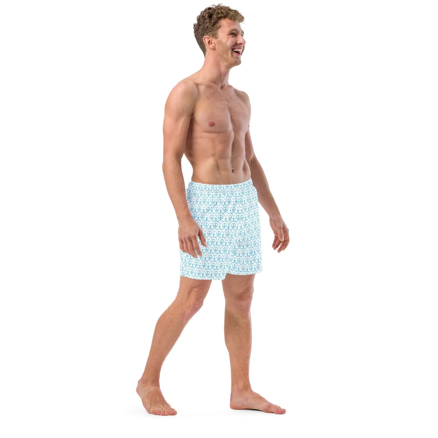 Man wearing Recycled Peace Love Paddleboard Swim Trunks, smiling and walking, perfect for summer fun.