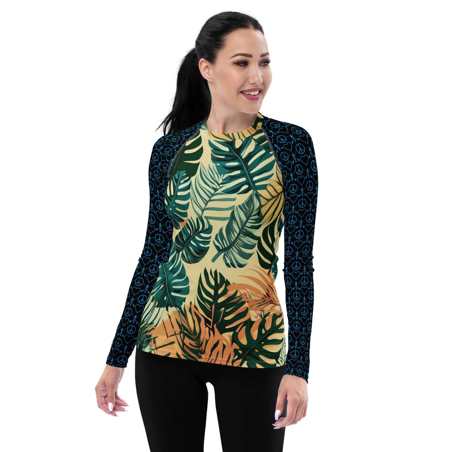 Active woman wearing a stylish long-sleeve rash guard with colorful tropical leaf design and comfortable fit.
