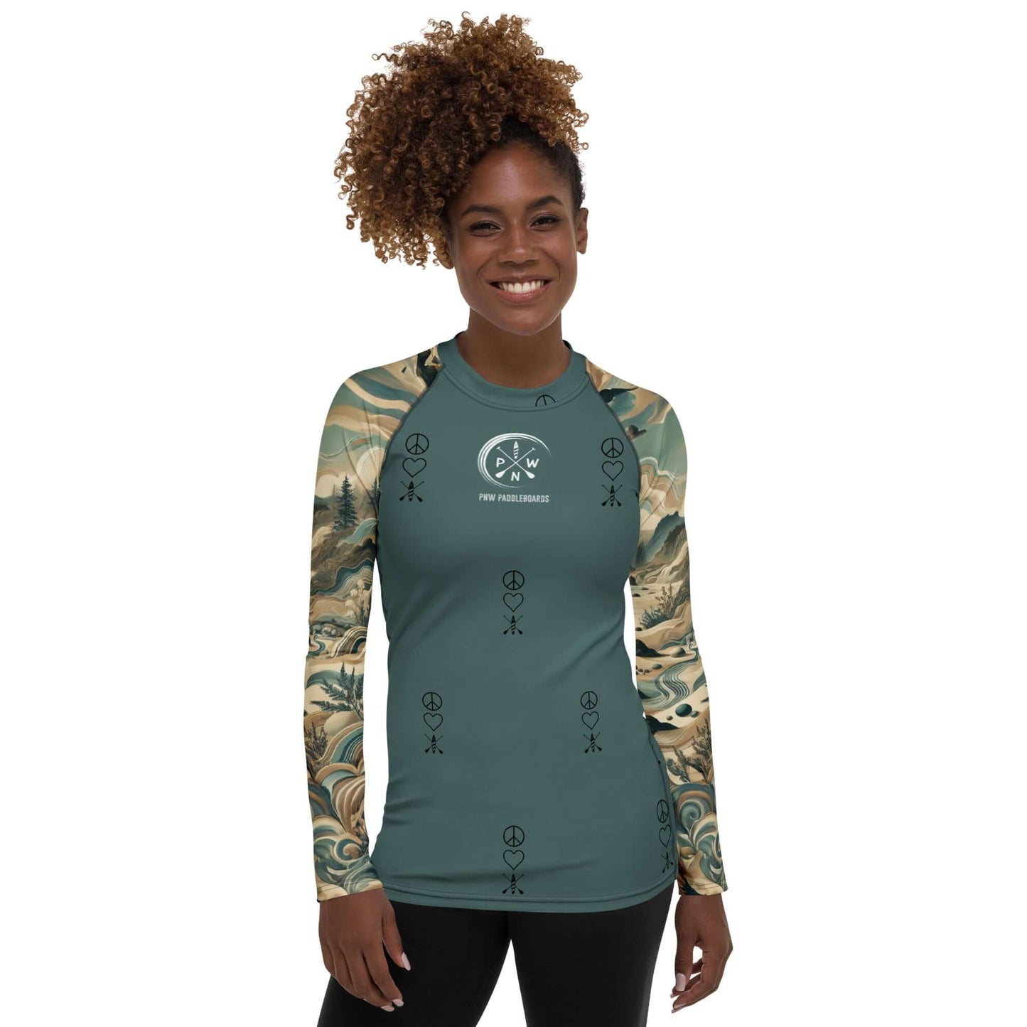 Woman in a PNW pattern long-sleeve rash guard featuring peace symbols, perfect for sun protection during activities.