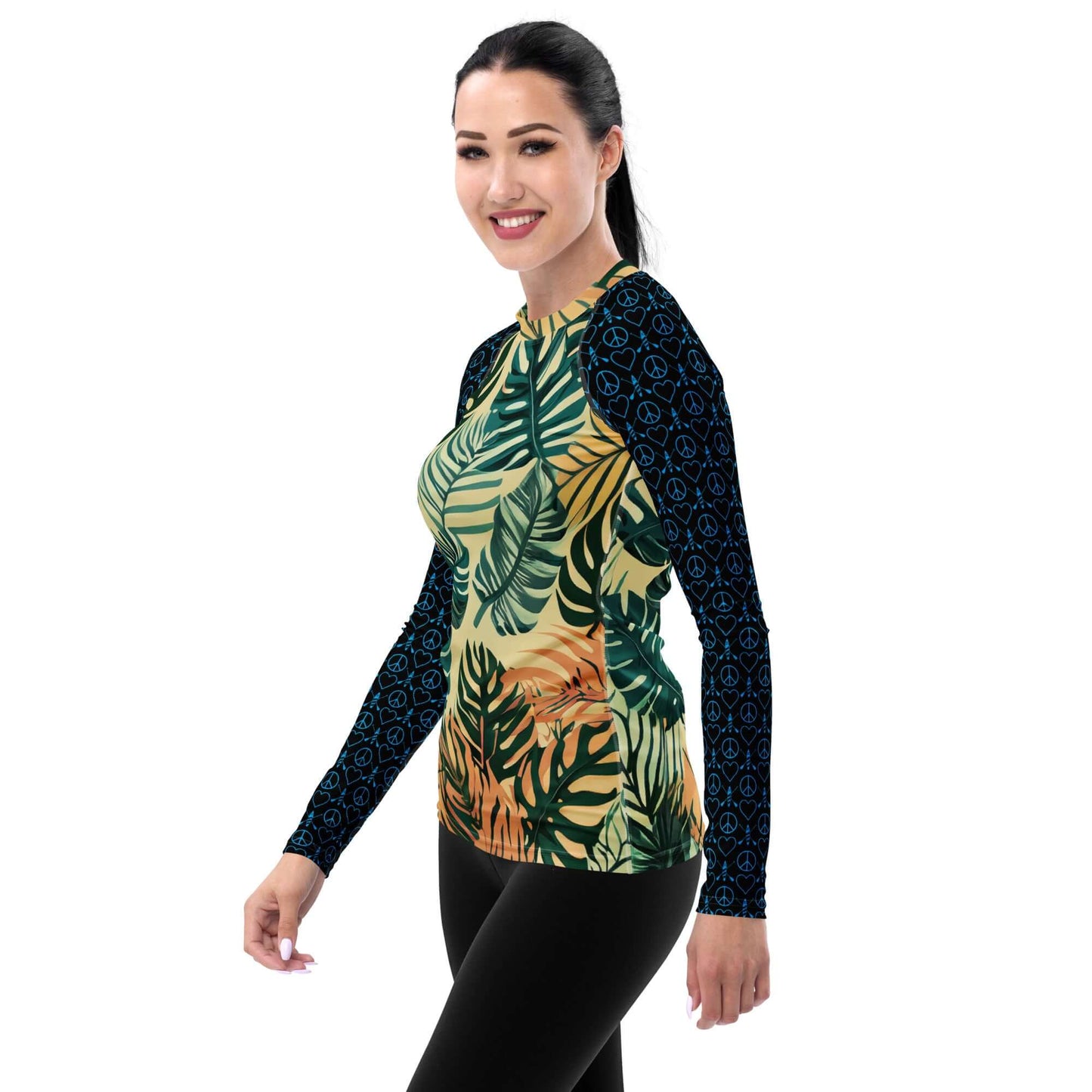 Woman wearing a colorful long-sleeve paddleboard rash guard with tropical leaves design.